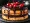 Chocolate cake with vibrant red cherries on top, signifying a perfect blend of chocolatey goodness and fruity freshness.