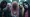 Group of people wearing masks at a gathering.