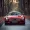 Premium red luxury car on the road, front view.