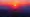 Two people standing on a stunning mountain vista.